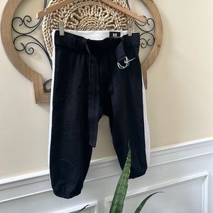 NIKE game day pants in men’s large.  Black with white stripe on leg.  EUC